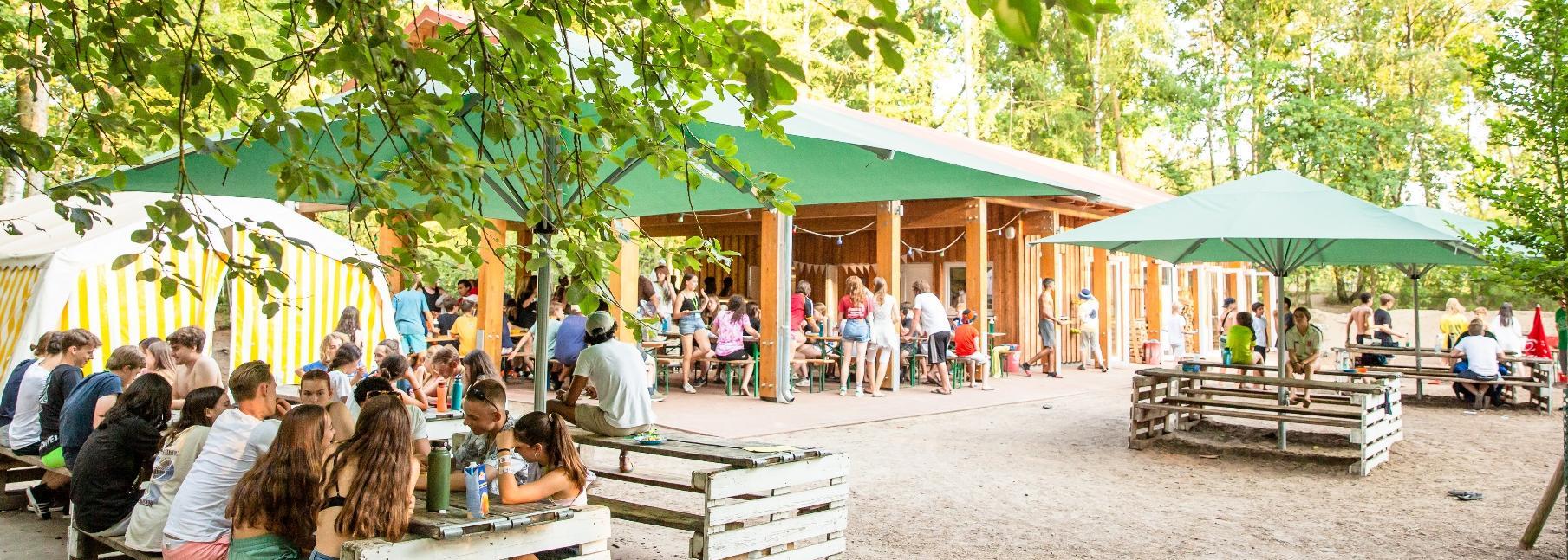 Outdoor dining and meeting space at the forest camp
